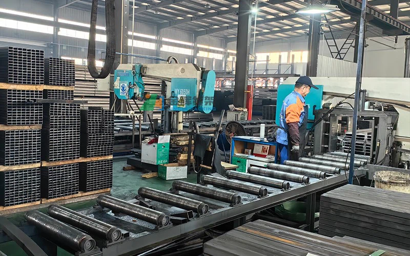 Automated metal profile processing line with operator Automated metal profile processing line with operator